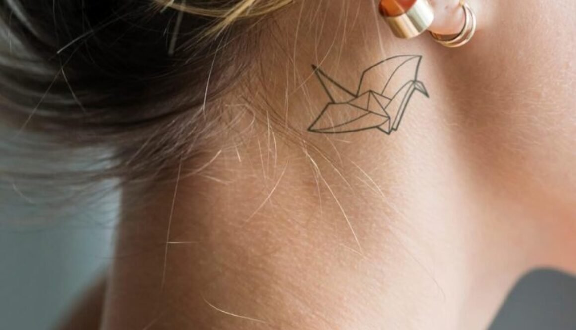 closeup-of-a-simple-behind-the-ear-tattoo-of-a-you-2026-01-07-23-29-03-utc